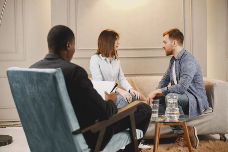 Terapeuta homem conversando com um casal no consultório